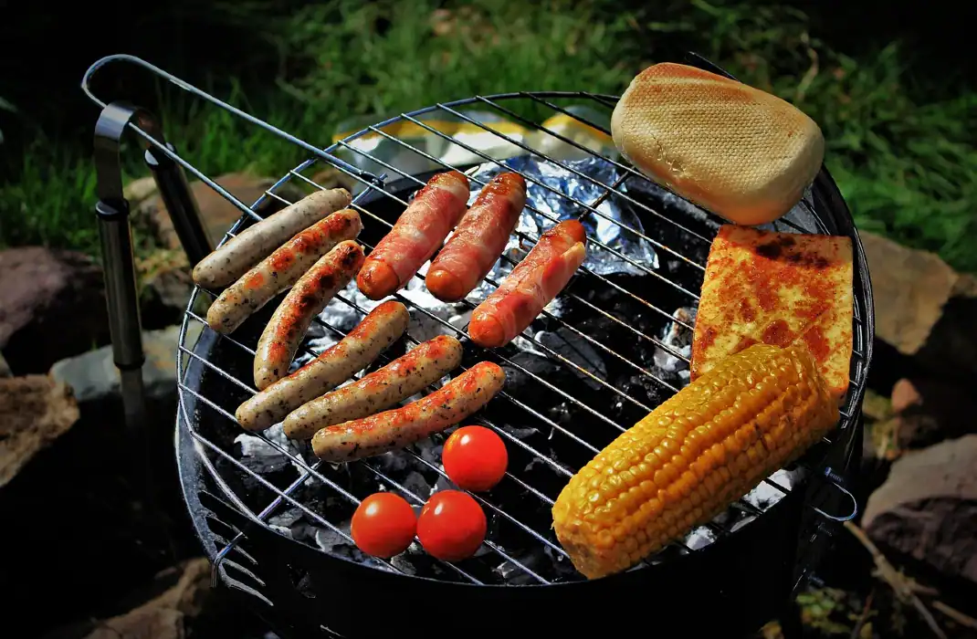 burgers and hotdogs being grilled