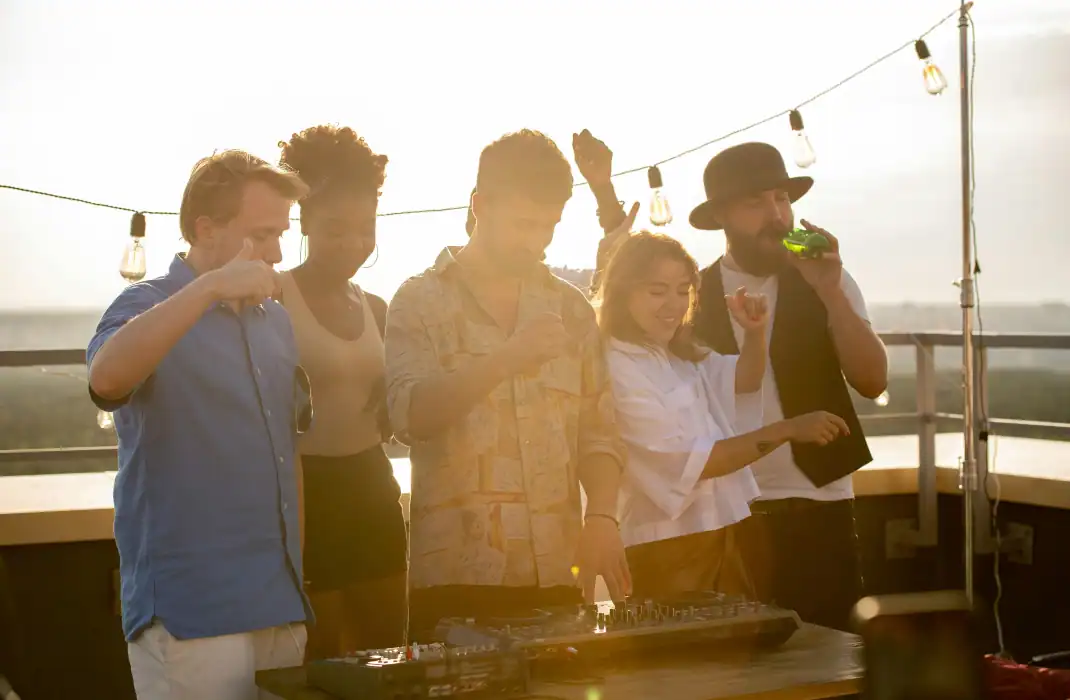 friend standing and dancing at rooftop party