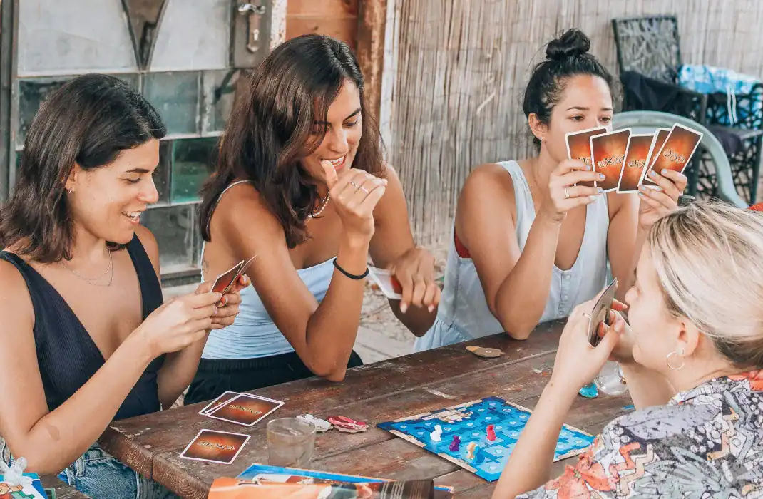 Girls playing board games during game night.