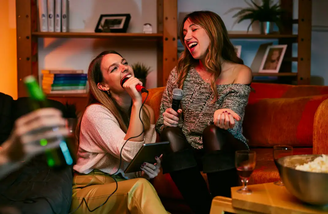 Women enjoying a bachelorette party at karaoke bar.