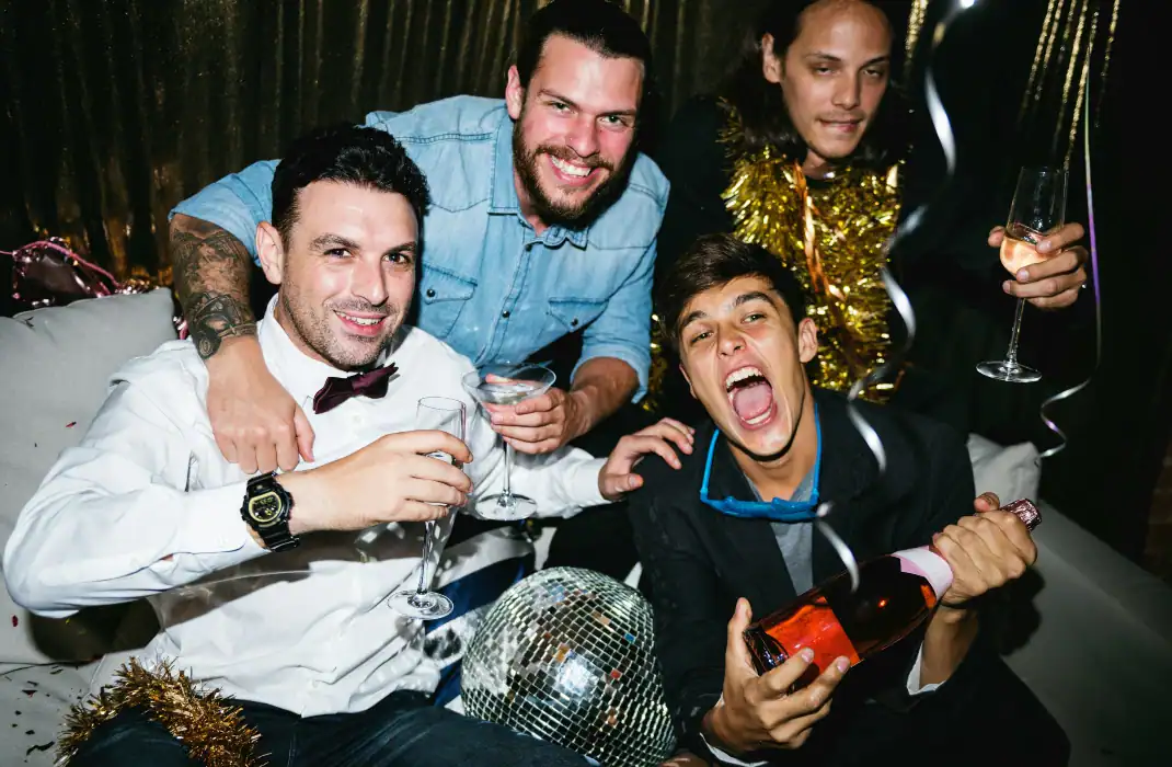 groom's male friends chatting and laughing during bachelor party
