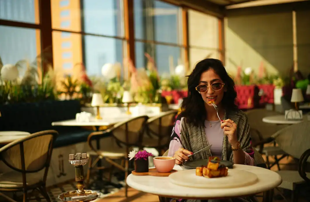 girl eating at a restaurant to celebrate solo birthday