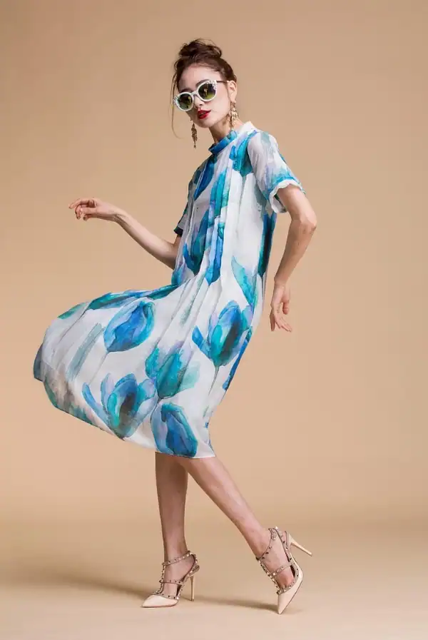 Woman wearing blue and white flowy summer dress and dress