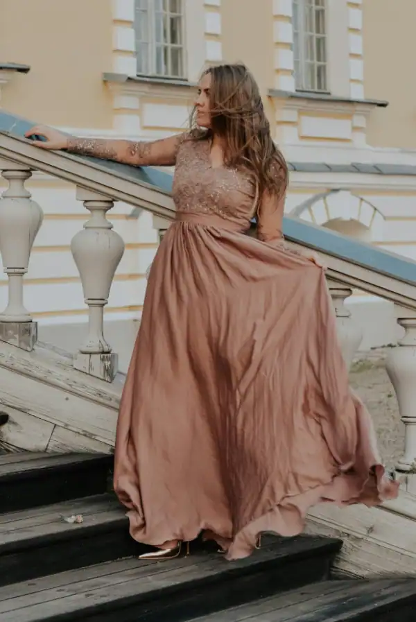 Lady wearing light brown floor-length dress