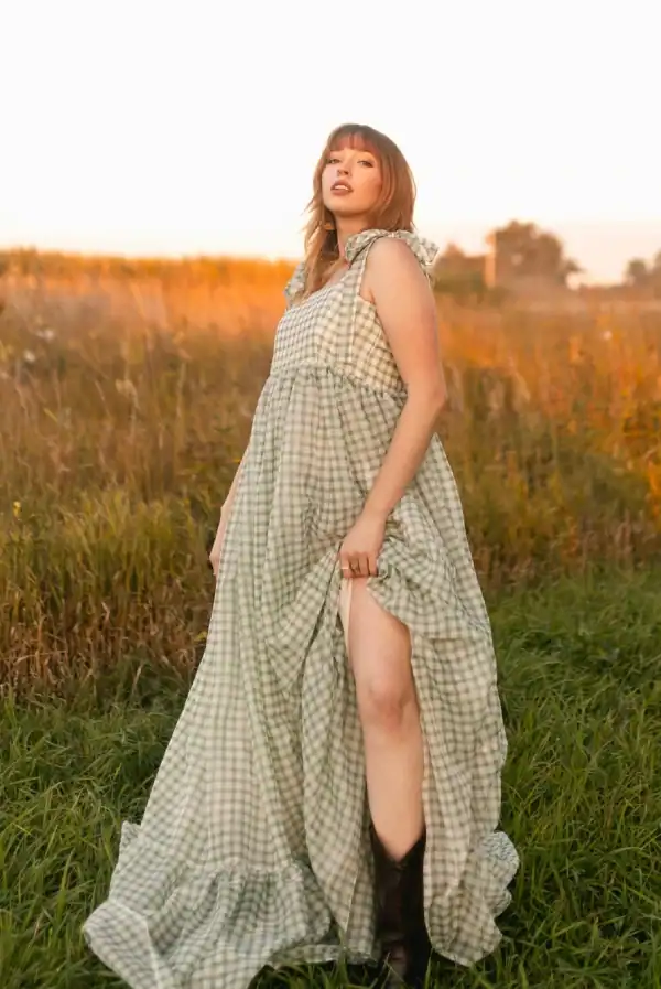 Woman wearing a long green dress in the grass