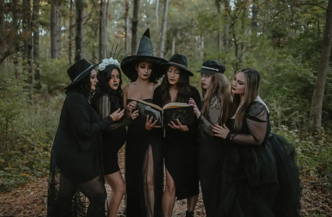group of girls in witch costumes