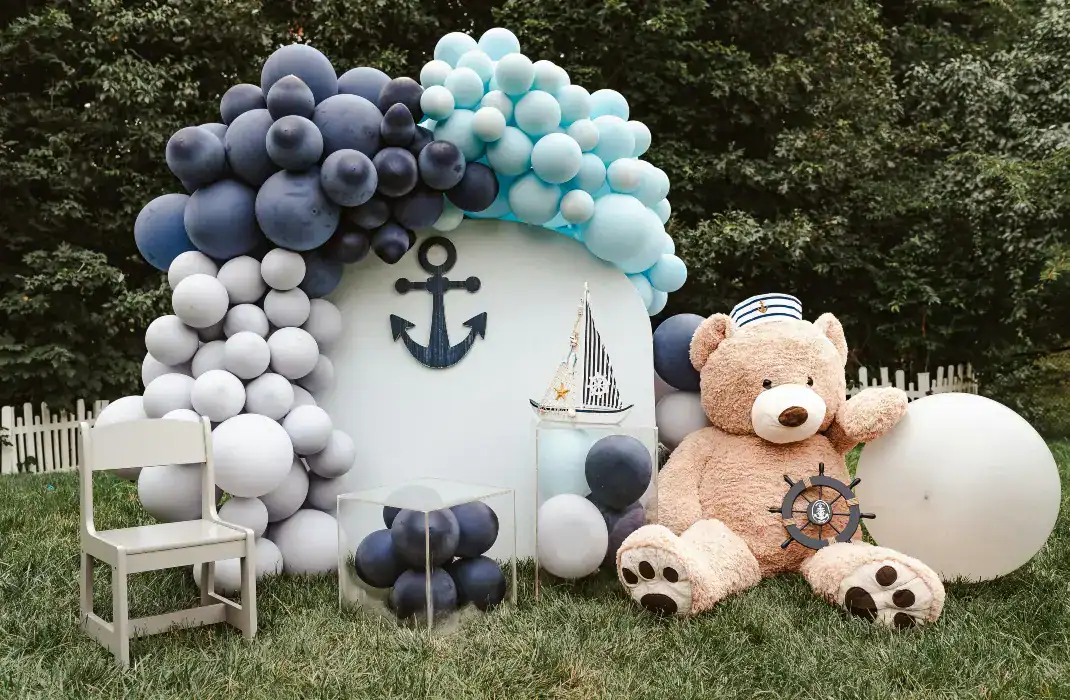 balloon arch over backboard next to giant teddy