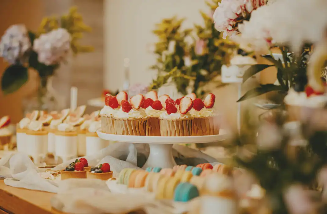 cakes, snacks and floral arrangements on display