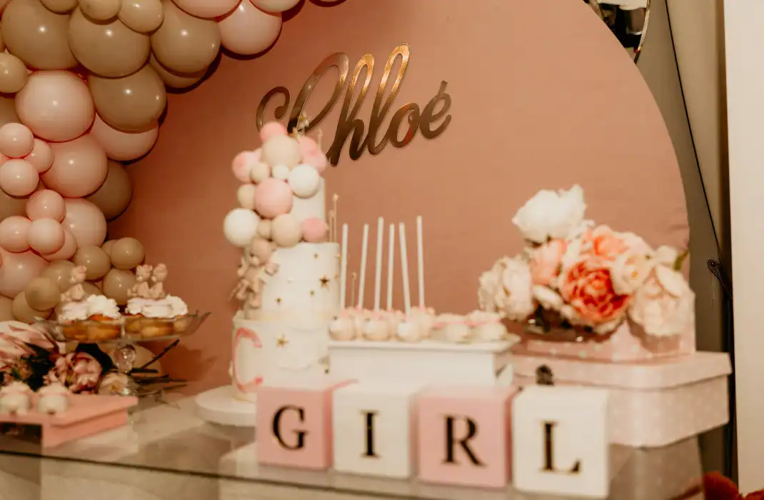 girl-themed backdrop, baloons and cake