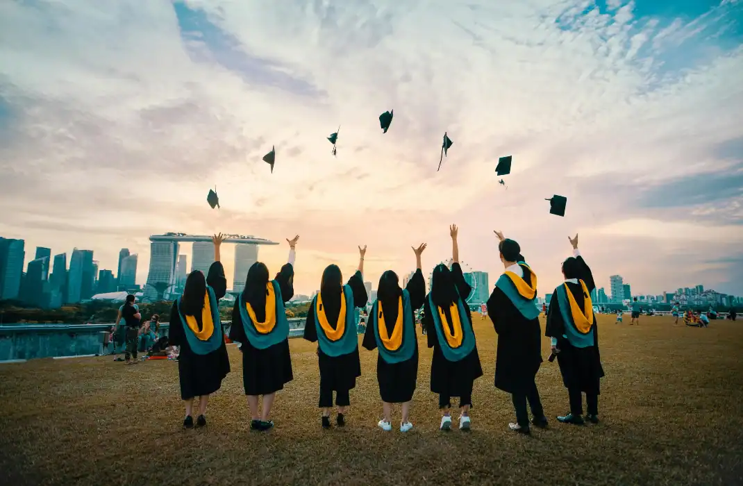 graduating students tossing their hats in the air