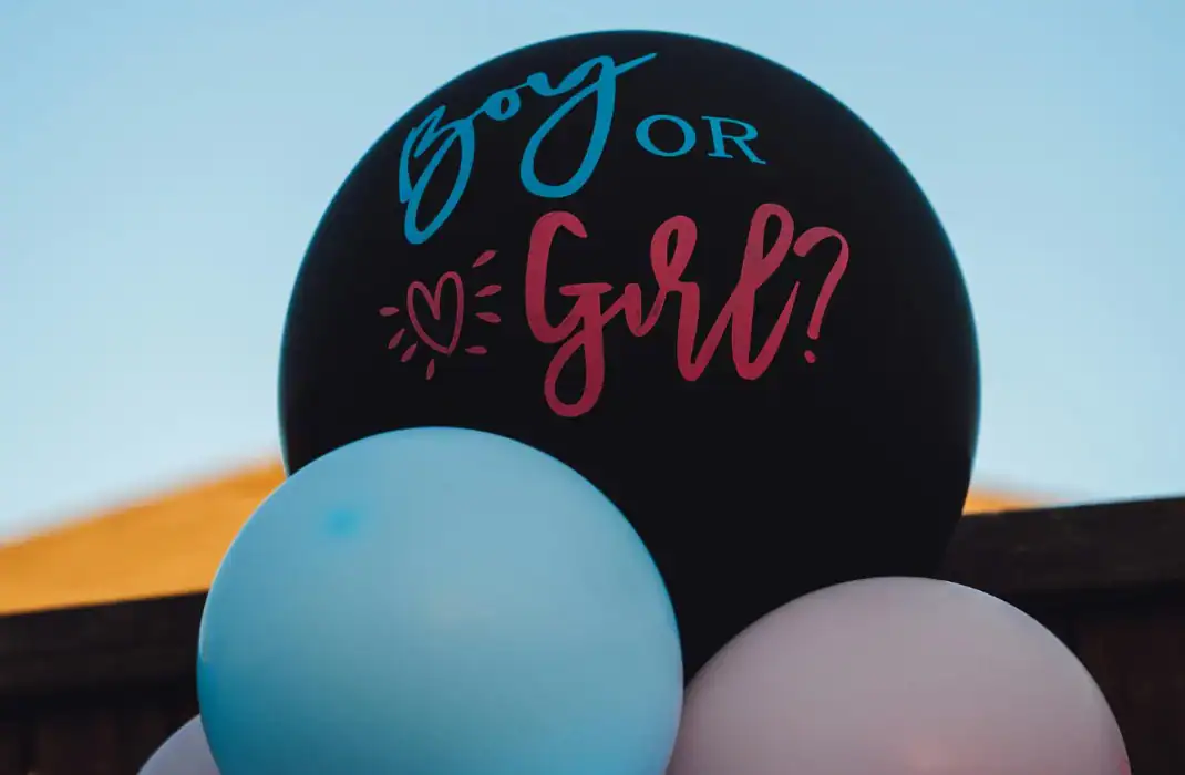 pink and blue balloons with one black balloon