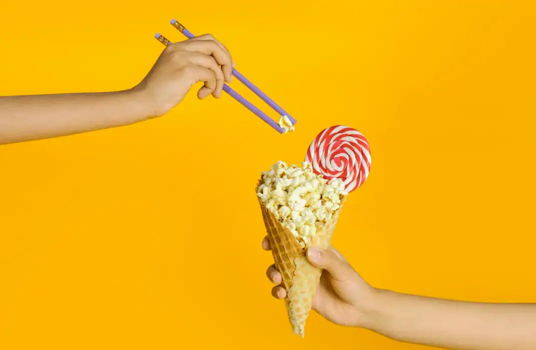 popcorn in a cone with a lollipop