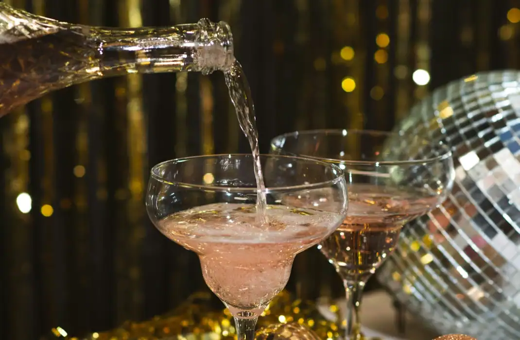 rose bubble being poured into champagne glass