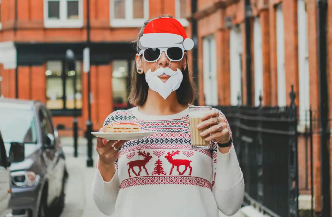 woman in christmas jumper and fake beard