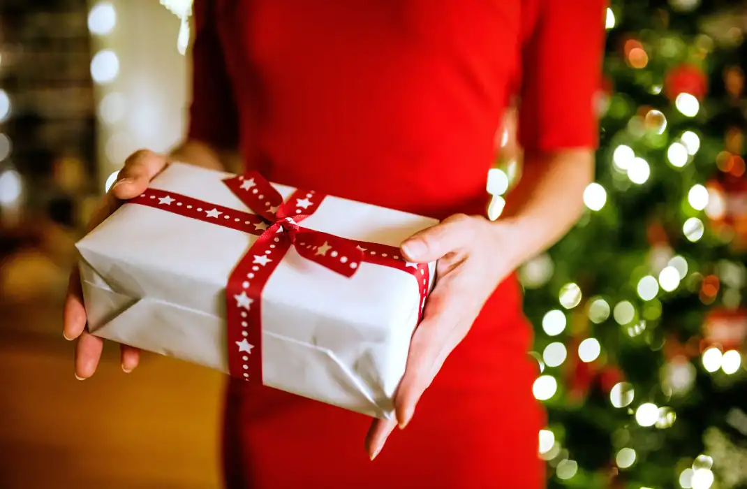woman in red dress holding gift