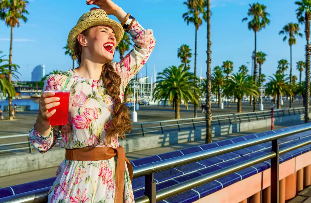 woman laughing holding red slushie